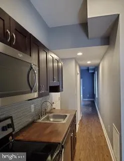 a view of a kitchen with a sink and cabinets