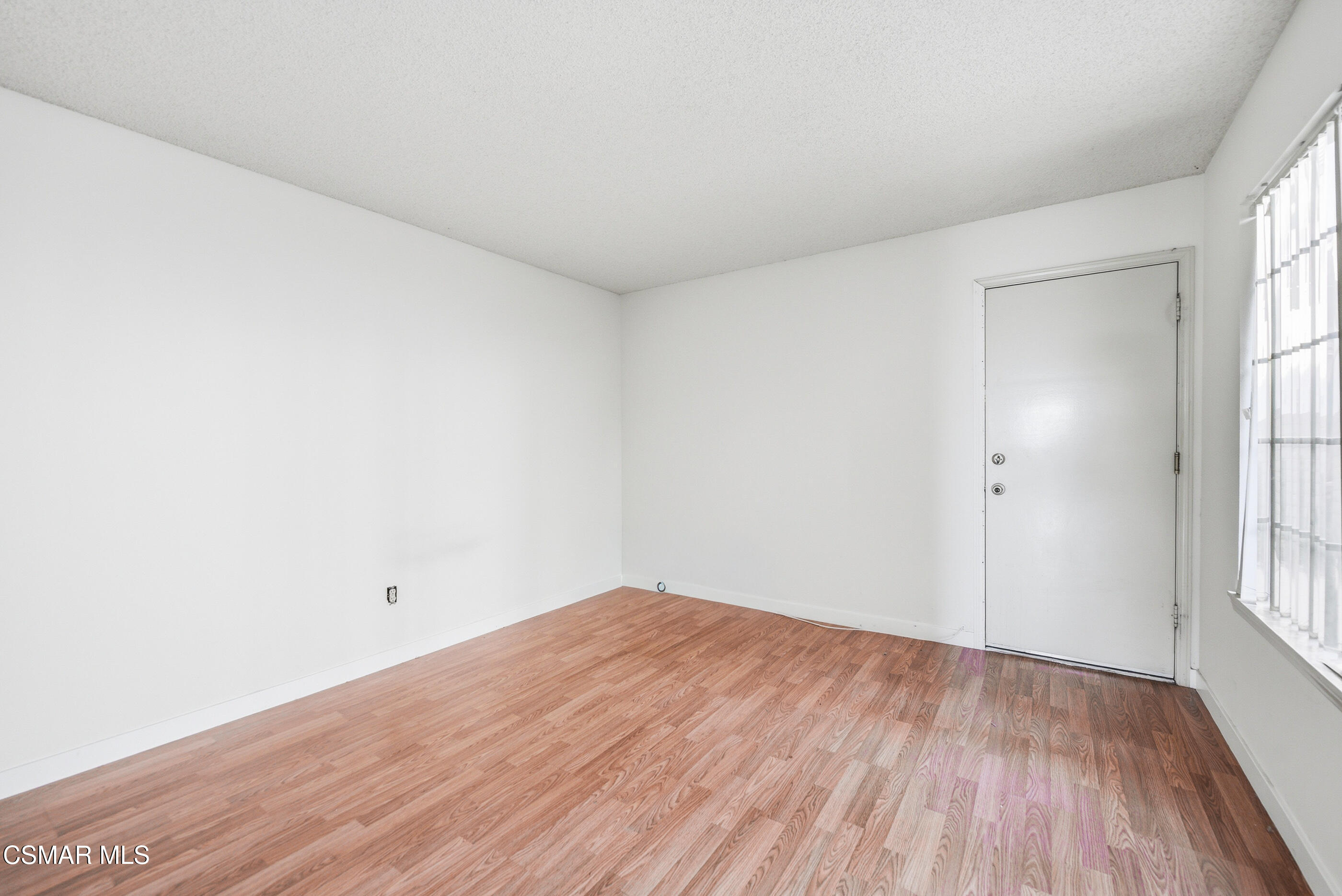 12036 Shadow Ridge Way Porter Ranch, CA 91326 - Photo 21 of 35 an empty room with wooden floor and windows
