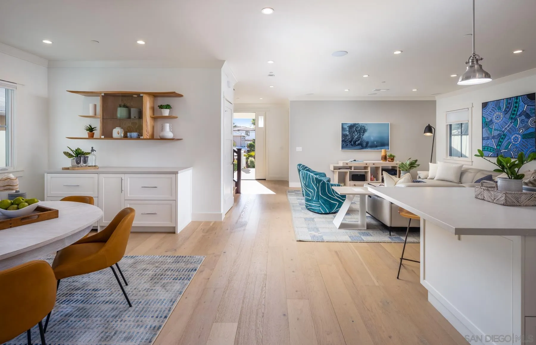 237 La Mesa Avenue Encinitas, CA 92024 - Photo 11 of 40 a living room with furniture a flat screen tv and kitchen view