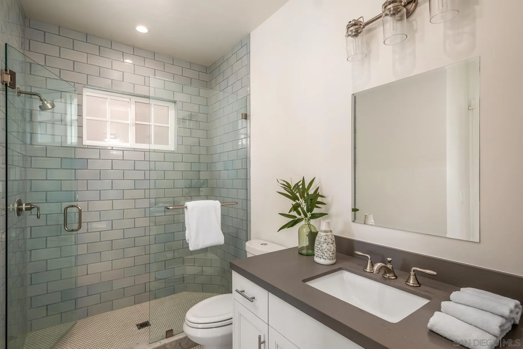 237 La Mesa Avenue Encinitas, CA 92024 - Photo 14 of 40 a bathroom with a sink a toilet a mirror and shower