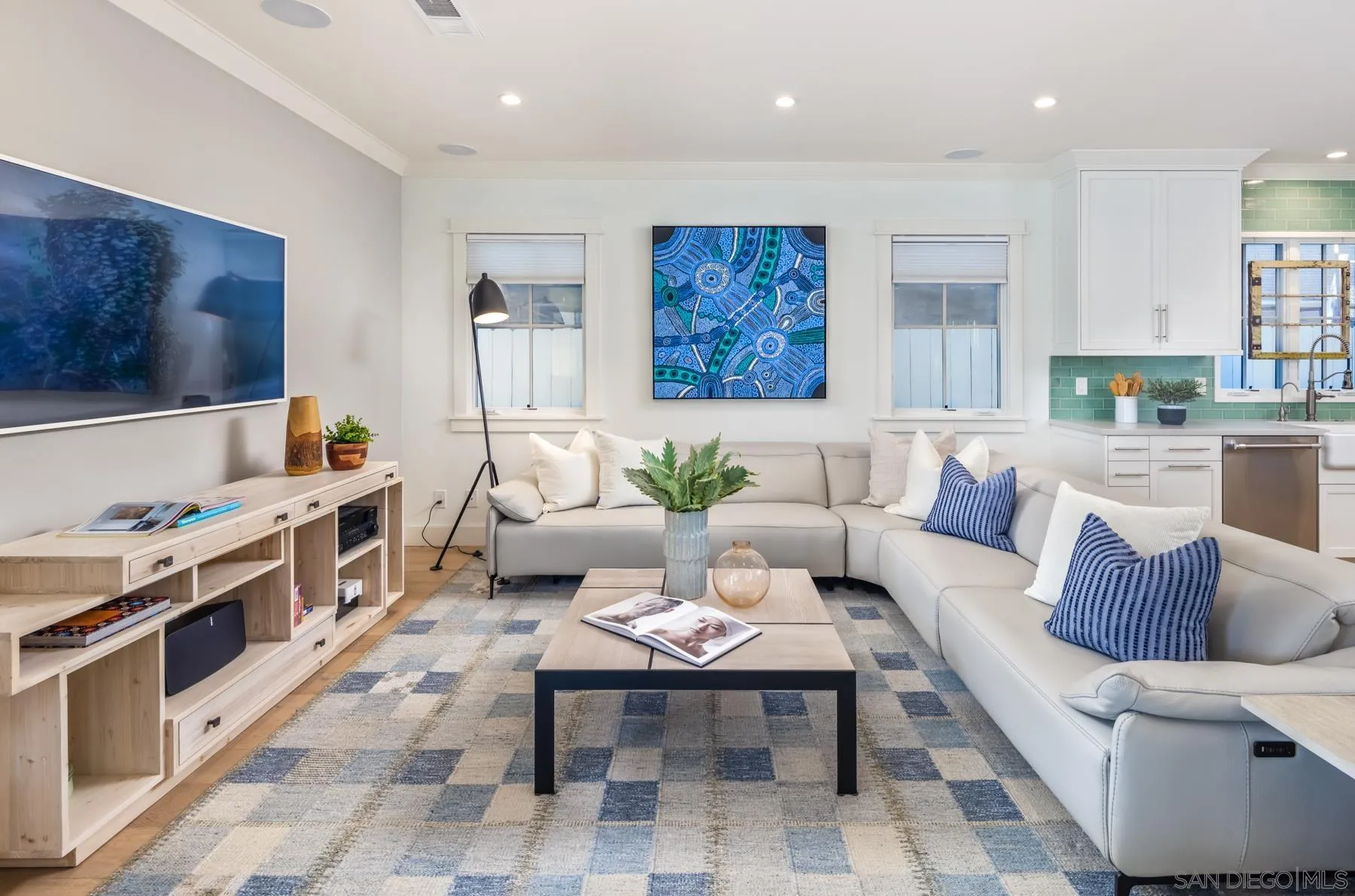 237 La Mesa Avenue Encinitas, CA 92024 - Photo 3 of 40 a living room with furniture a flat screen tv and kitchen view