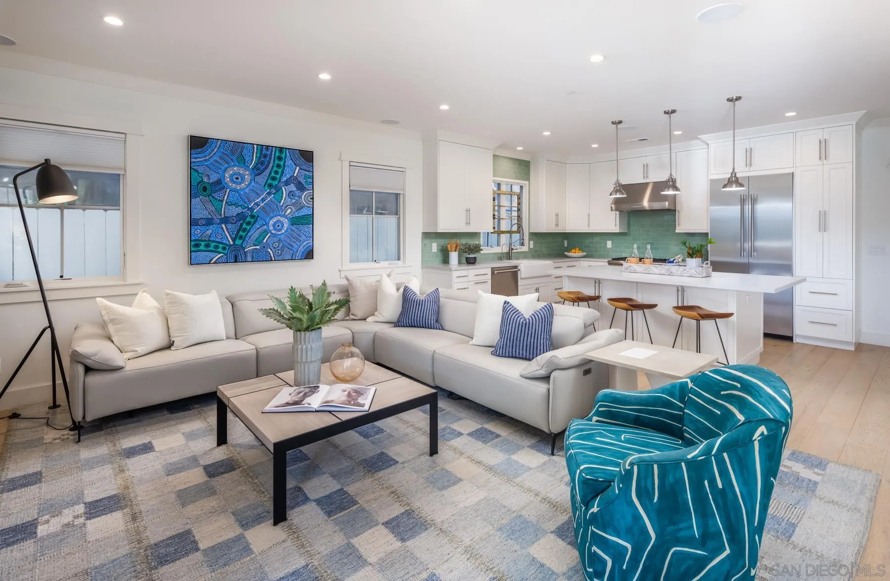 237 La Mesa Avenue Encinitas, CA 92024 - Photo 4 of 40 a living room with furniture a rug and a kitchen view