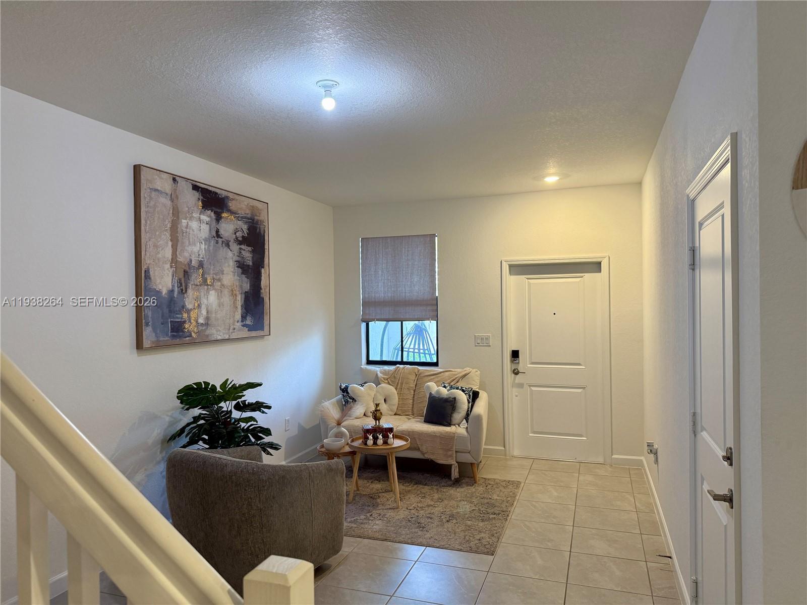 23049 Southwest 129th Place Miami, FL 33177 - Photo 3 of 29 a living room with furniture and a potted plant