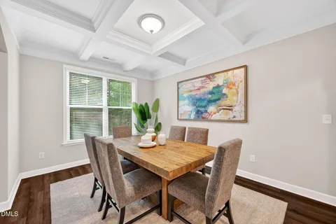 a dining room with furniture a rug and wooden floor