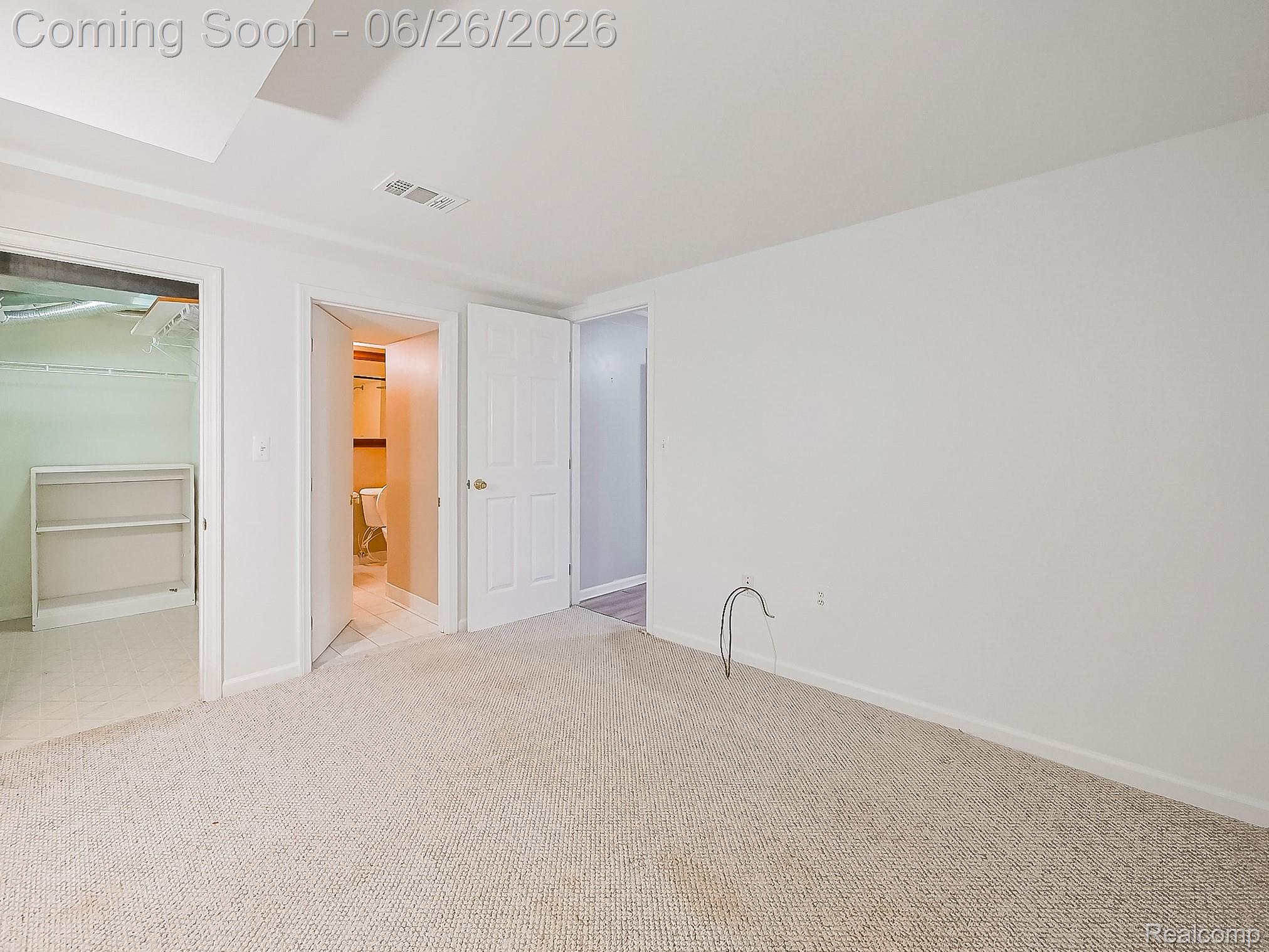 160 Pine Tree Ridge, Unit 3 Waterford, MI 48327 - Photo 14 of 26 Carpeted room with white walls, featuring a built-in closet with shelving, a white paneled door, and ceiling-mounted air vent