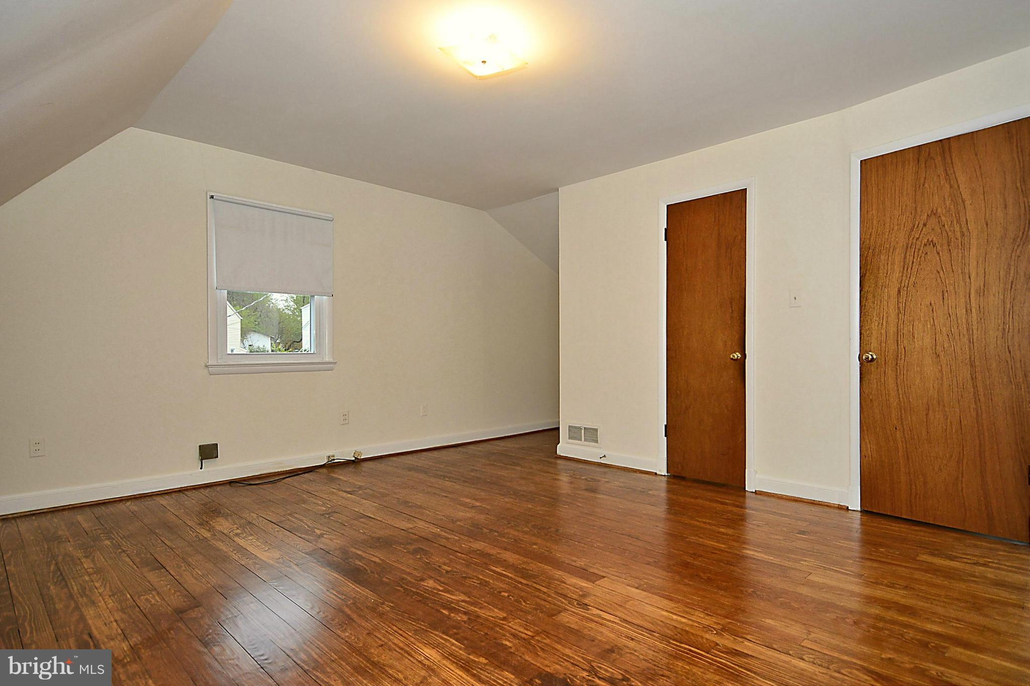 2507 Sheraton Street Silver Spring, MD 20906 - Photo 16 of 23 an empty room with wooden floor and windows