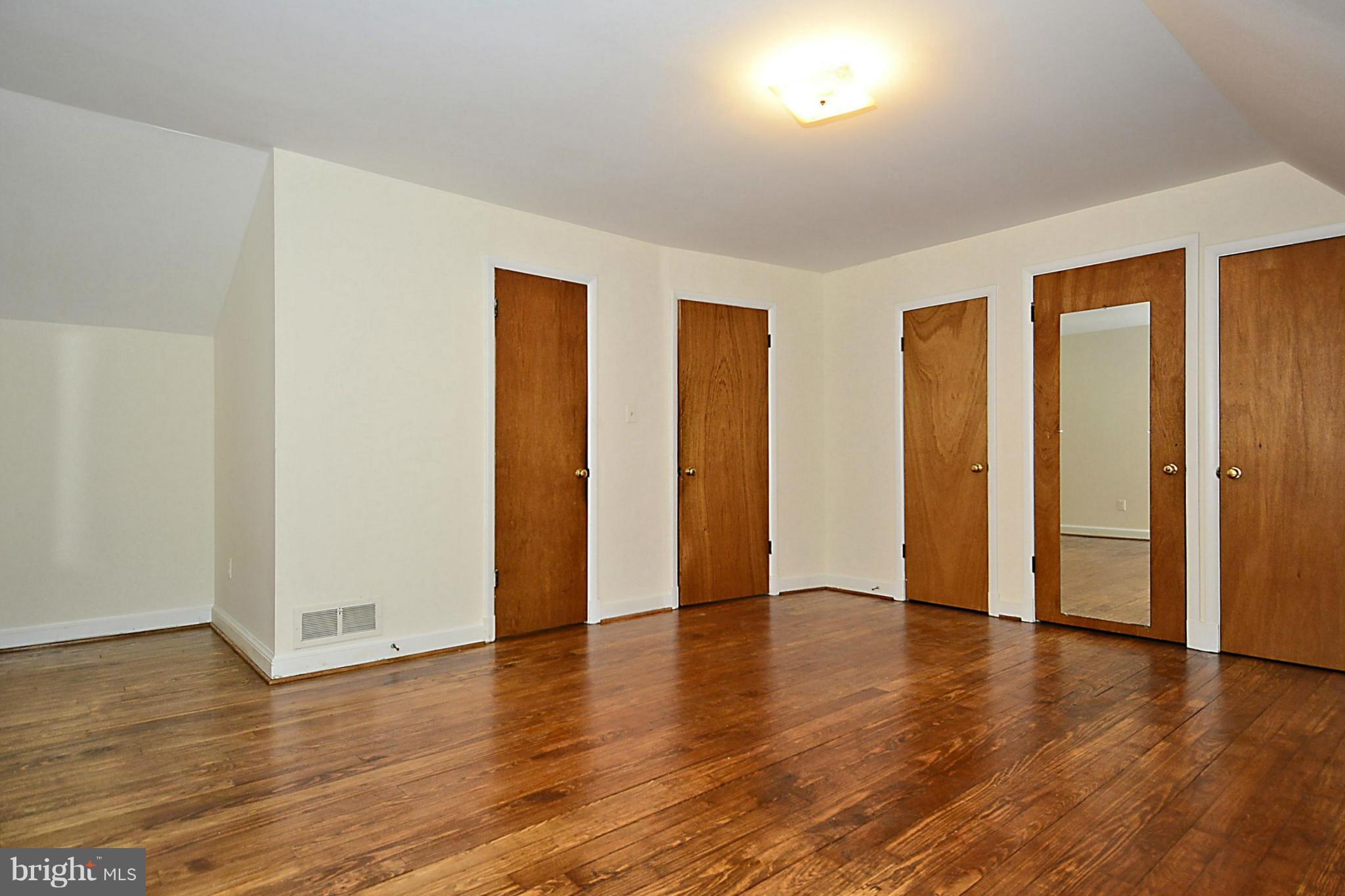 2507 Sheraton Street Silver Spring, MD 20906 - Photo 18 of 23 an empty room with wooden floor and windows