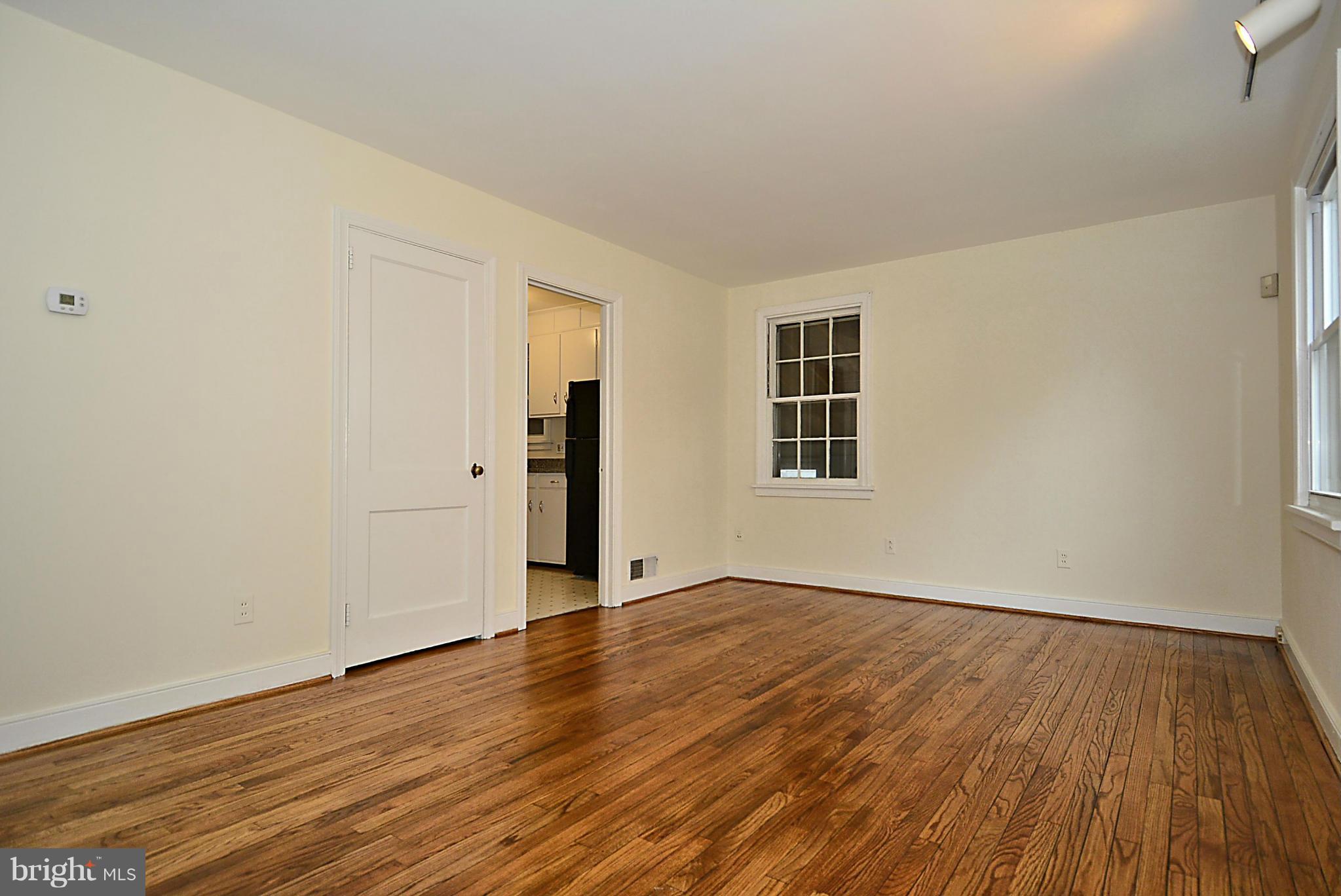 2507 Sheraton Street Silver Spring, MD 20906 - Photo 4 of 23 a view of an empty room with wooden floor and a window