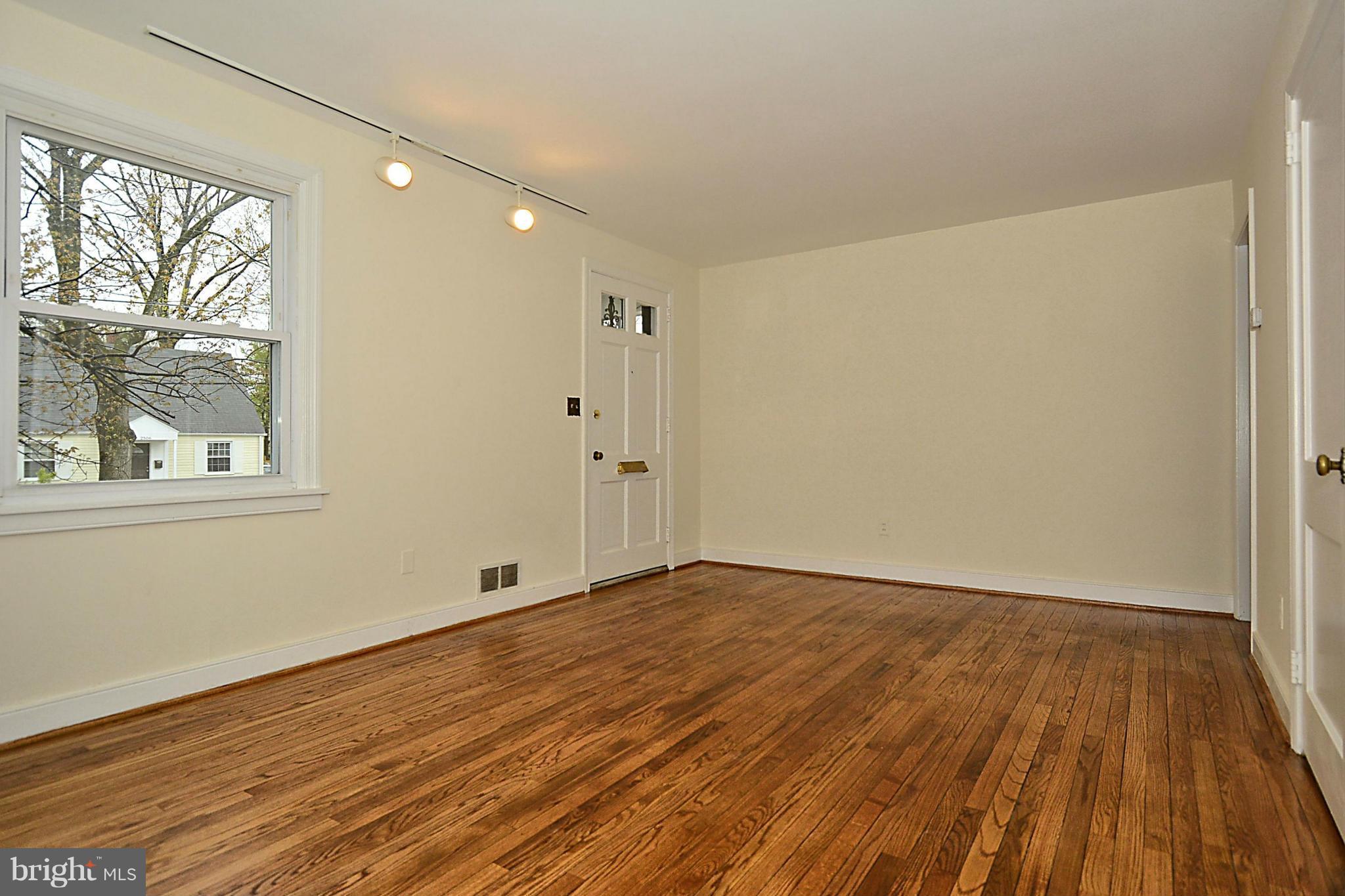 2507 Sheraton Street Silver Spring, MD 20906 - Photo 5 of 23 a view of an empty room with wooden floor and a window