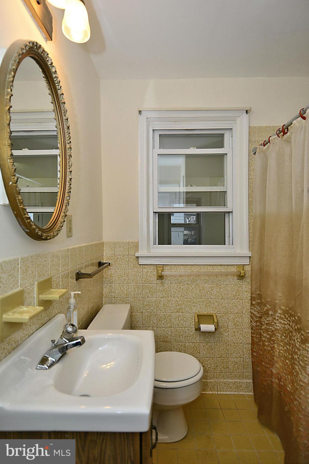 2507 Sheraton Street Silver Spring, MD 20906 - Photo 7 of 23 a bathroom with a sink a mirror and a toilet