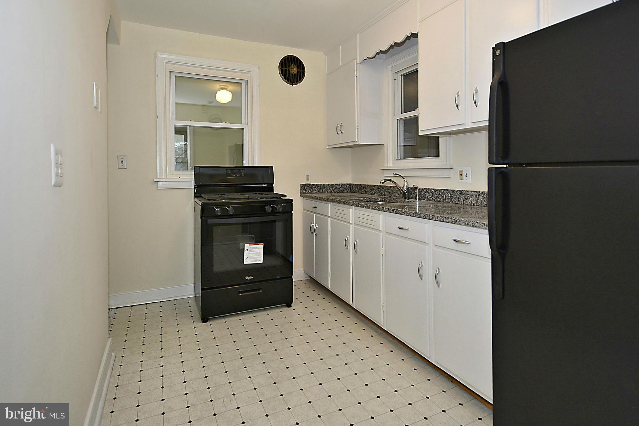 2507 Sheraton Street Silver Spring, MD 20906 - Photo 8 of 23 a kitchen with granite countertop a refrigerator stove and sink