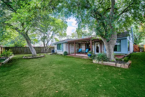 a view of a house with a yard and sitting area