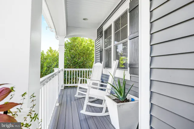 a view of a two chair in the patio with potted plants