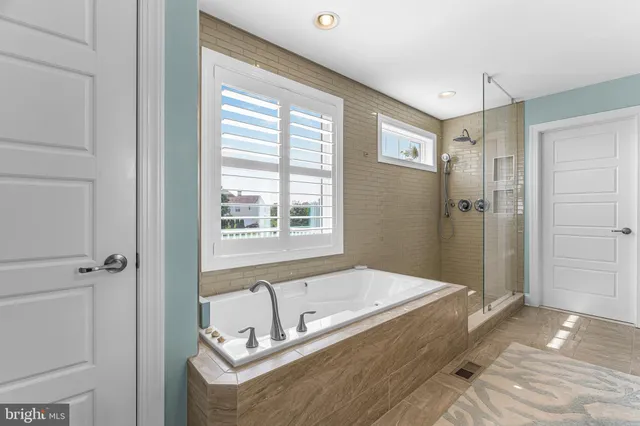 a bedroom with a large bed couch and a window