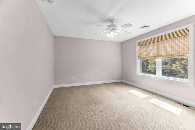 a dining room with kitchen island furniture a chandelier a large window and white kitchen view