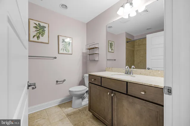 a group of people sitting in center of a table and chairs in a room