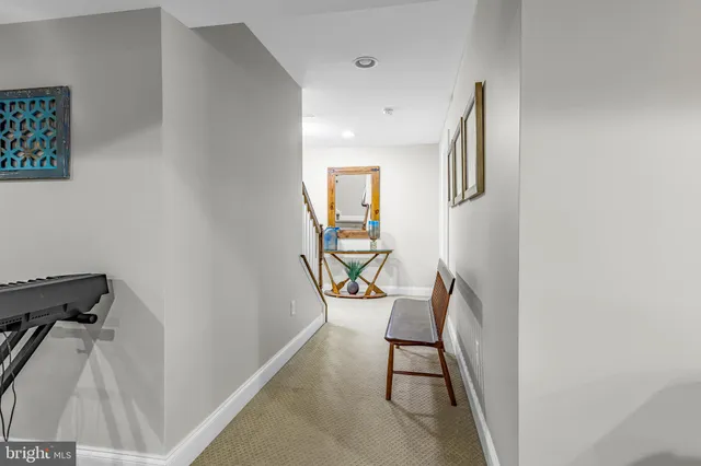 a view of a patio with table and chairs potted plants with floor to ceiling window