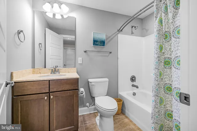 an aerial view of a house with a garden and lake view