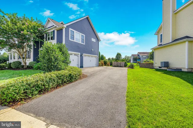 a kitchen with stainless steel appliances a dining table chairs stove and refrigerator
