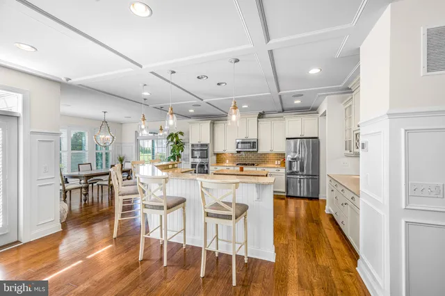 a large kitchen with a table and chairs in it