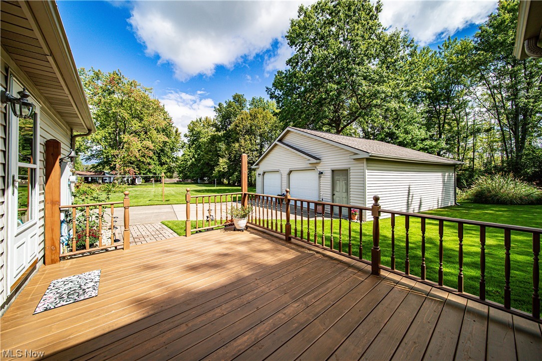 431 Ansel Road Geneva, OH 44041 - Photo 11 of 35 Deck with garage and a lawn