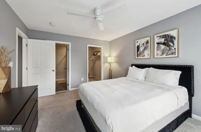 a bedroom with bed and painting on the wall