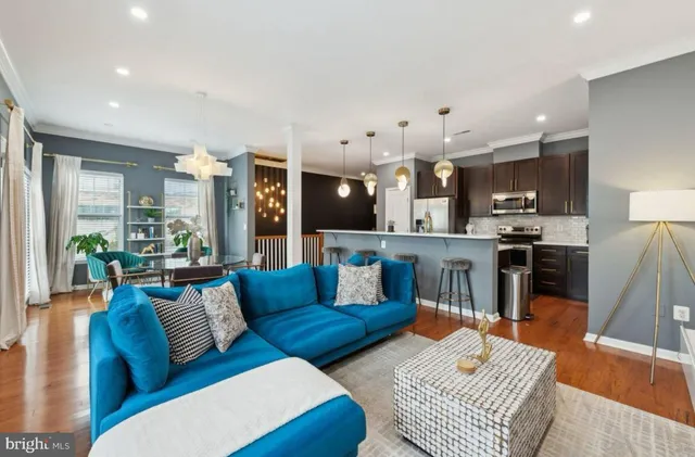 a living room with furniture kitchen and a table
