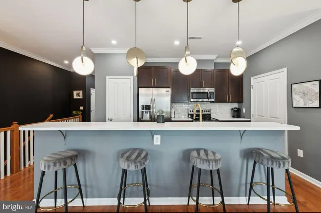 a view of a kitchen with sink and wooden floor