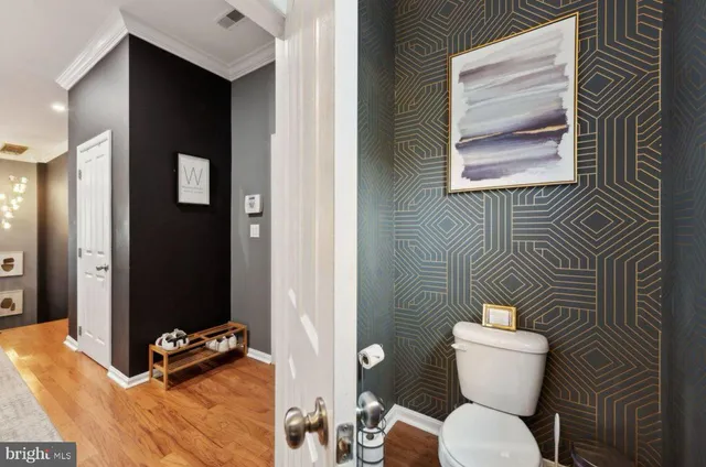 a bathroom with a toilet and a shower curtain