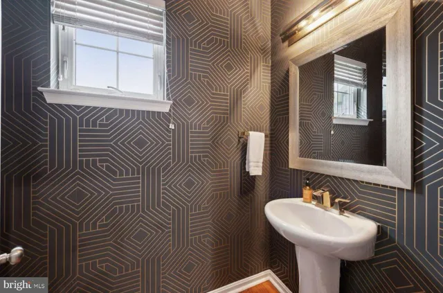 a bathroom with a sink a mirror and a toilet