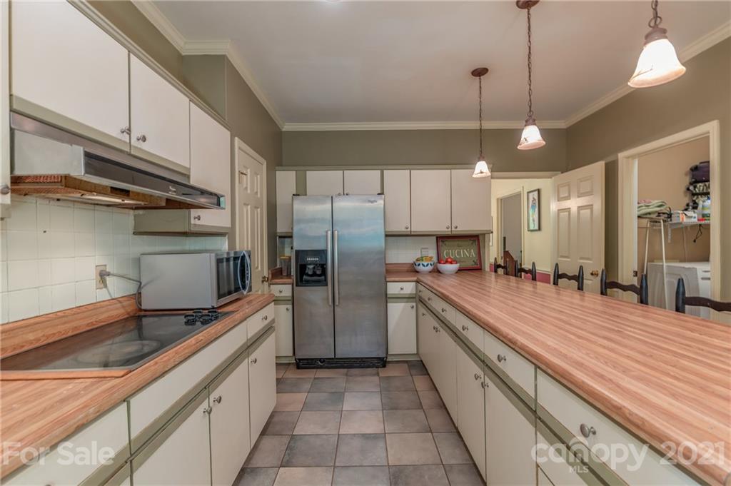 4733 Hunting Country Road Tryon, NC 28782 - Photo 16 of 48 a large kitchen with a large counter top stainless steel appliances and cabinets
