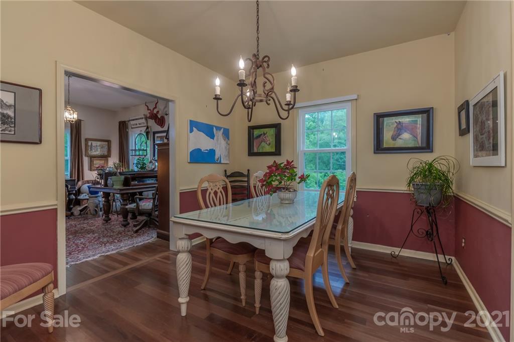 4733 Hunting Country Road Tryon, NC 28782 - Photo 19 of 48 a view of a dining room with furniture and chandelier