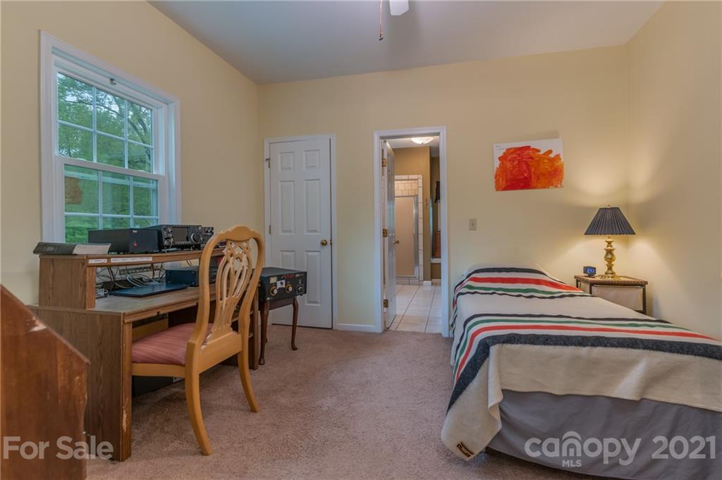 4733 Hunting Country Road Tryon, NC 28782 - Photo 22 of 48 a bedroom with a bed a desk and chair