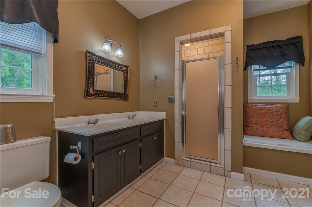 4733 Hunting Country Road Tryon, NC 28782 - Photo 23 of 48 a bathroom with a sink a toilet and shower