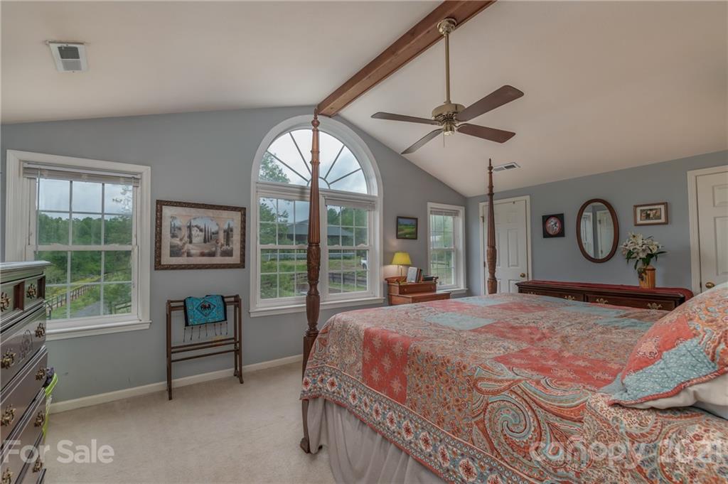 4733 Hunting Country Road Tryon, NC 28782 - Photo 28 of 48 a bedroom with a bed and a large window with the outer view