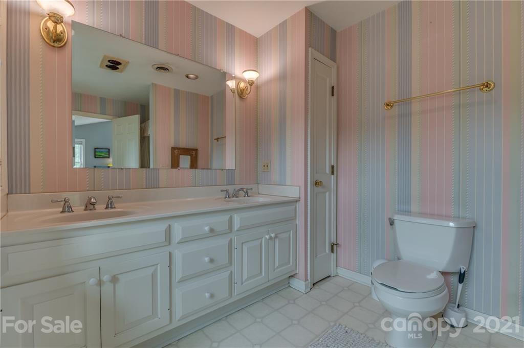 4733 Hunting Country Road Tryon, NC 28782 - Photo 30 of 48 a bathroom with a toilet sink and mirror