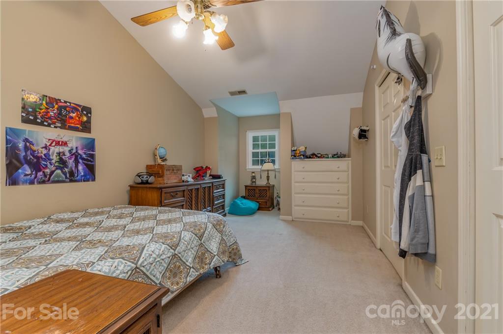 4733 Hunting Country Road Tryon, NC 28782 - Photo 36 of 48 a bedroom with a bed and a chandelier