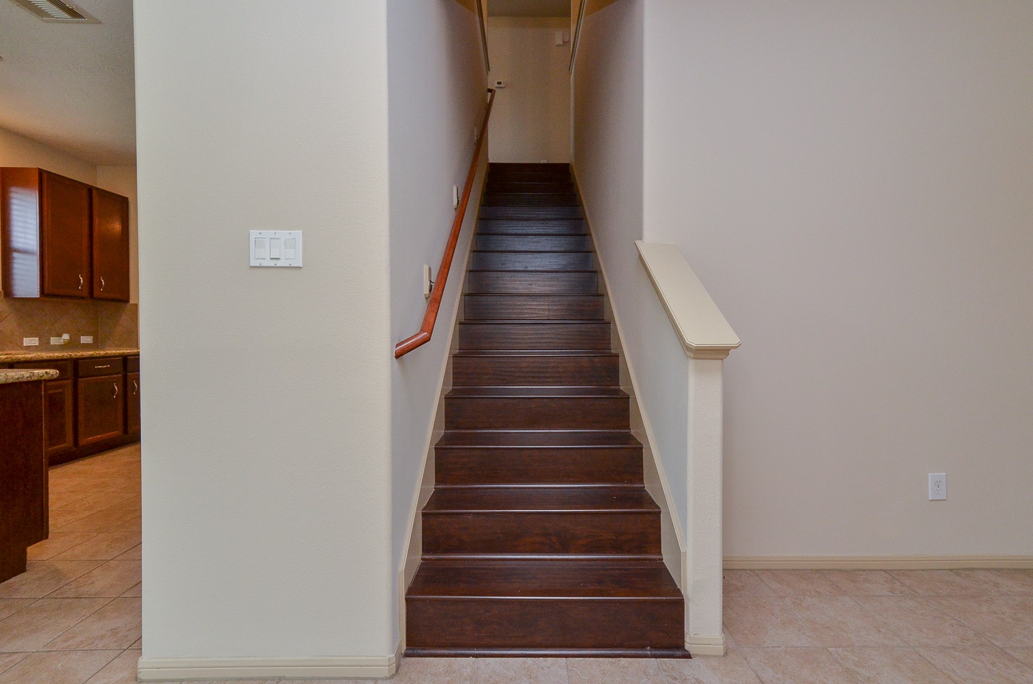 25135 Ginger Ranch Drive Katy, TX 77494 - Photo 6 of 32 A centrally located staircase with wood-style steps provides convenient access to the second floor and connects the main living areas with the upper level.