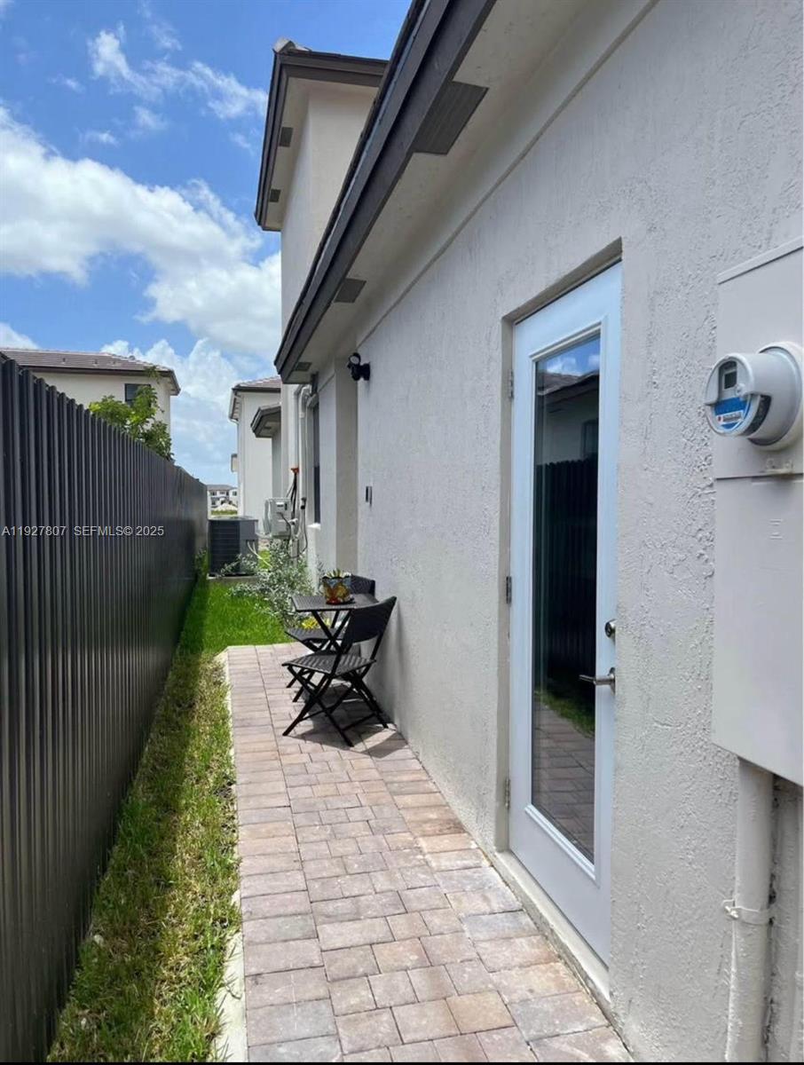 12950 Southwest 229th Lane, Unit 2 Miami, FL 33170 - Photo 1 of 6 a view of a porch with furniture and floor to ceiling window