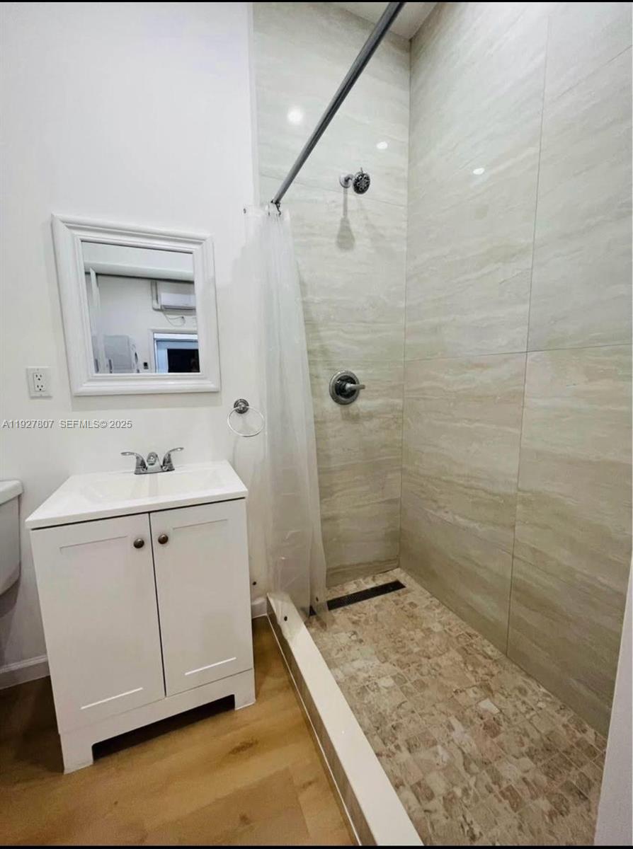 12950 Southwest 229th Lane, Unit 2 Miami, FL 33170 - Photo 5 of 6 a bathroom with a sink a vanity a mirror and shower