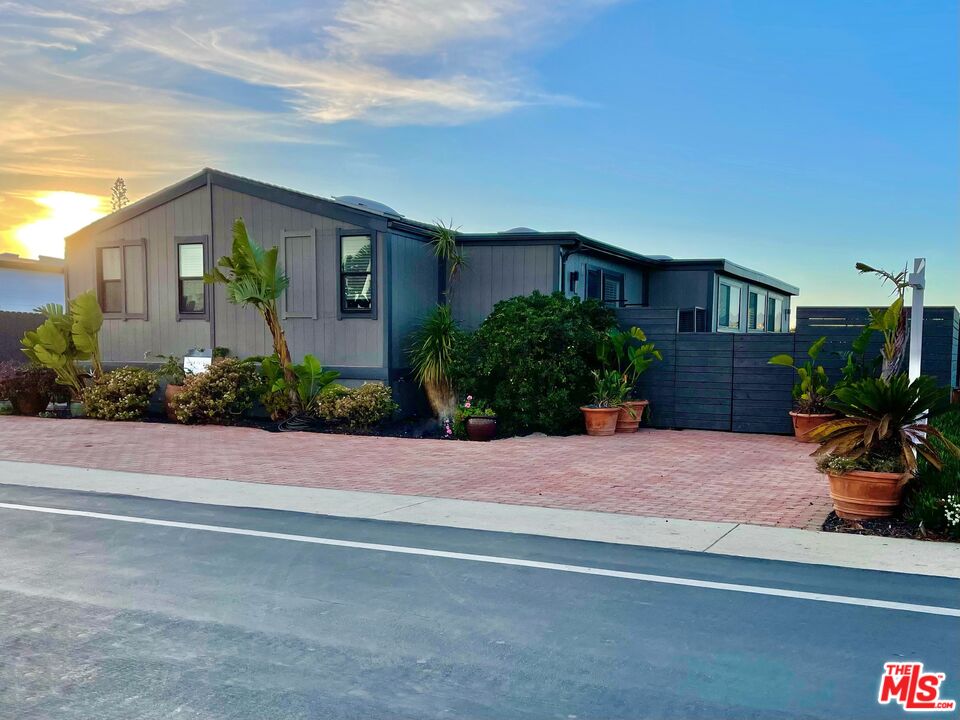 29500 Heathercliff Road, Unit 260 Malibu, CA 90265 - Photo 1 of 23 a front view of a house with a yard and potted plants