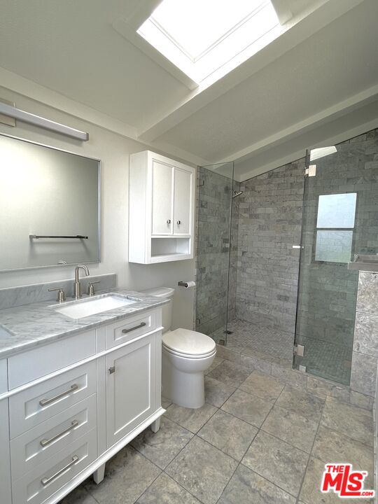 29500 Heathercliff Road, Unit 260 Malibu, CA 90265 - Photo 11 of 23 a bathroom with a granite countertop sink a toilet and a shower