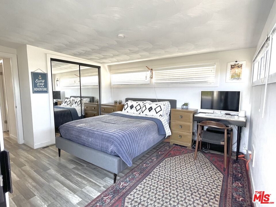 29500 Heathercliff Road, Unit 260 Malibu, CA 90265 - Photo 15 of 23 a bedroom with a bed and a flat screen tv