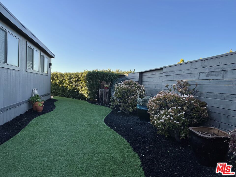 29500 Heathercliff Road, Unit 260 Malibu, CA 90265 - Photo 20 of 23 a view of a backyard with plants and a garden