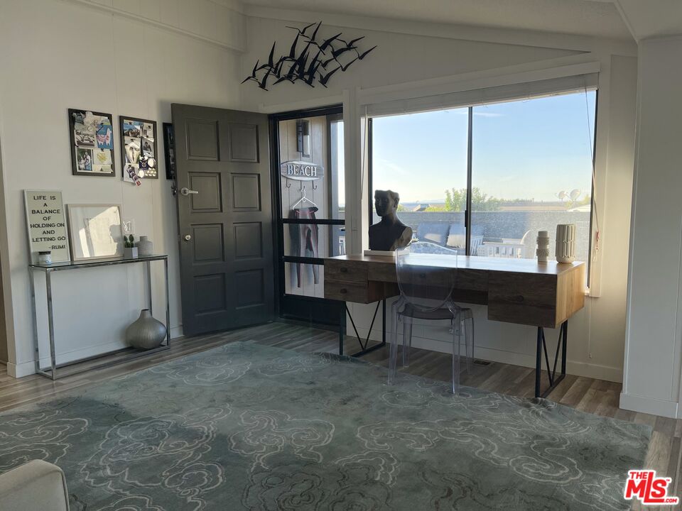 29500 Heathercliff Road, Unit 260 Malibu, CA 90265 - Photo 3 of 23 a dining room with furniture and a floor to ceiling window