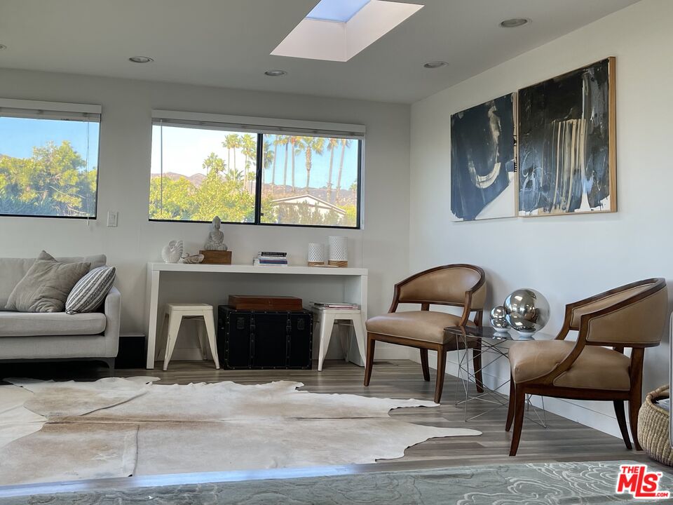 29500 Heathercliff Road, Unit 260 Malibu, CA 90265 - Photo 5 of 23 a living room with furniture a fireplace and a large window