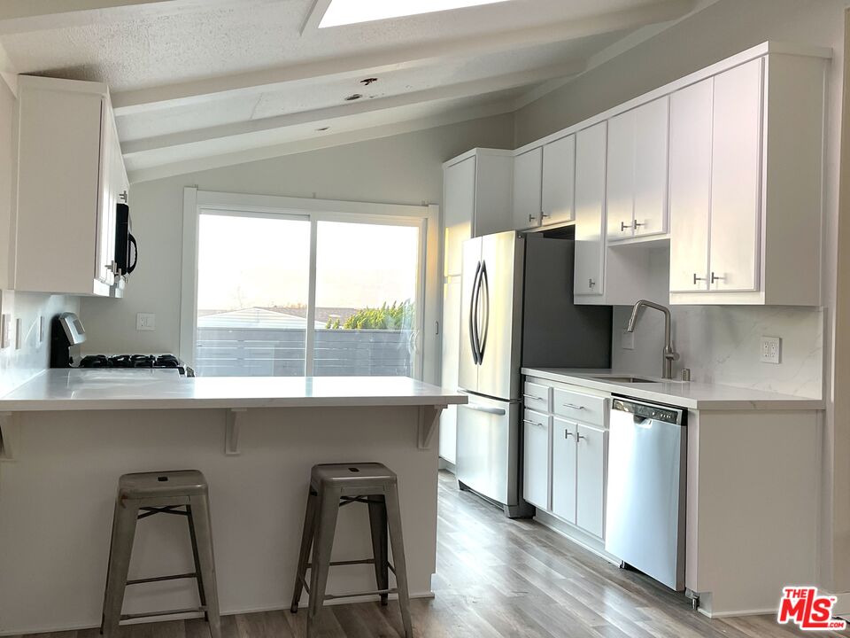 29500 Heathercliff Road, Unit 260 Malibu, CA 90265 - Photo 6 of 23 a kitchen with appliances cabinets and a large window