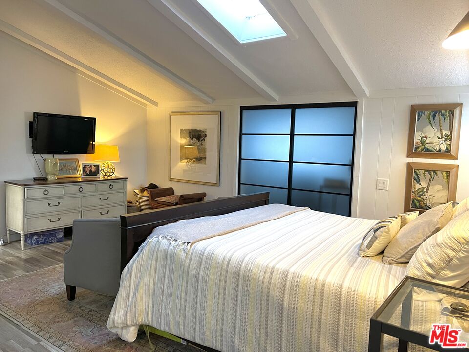 29500 Heathercliff Road, Unit 260 Malibu, CA 90265 - Photo 10 of 23 a bedroom with a bed and a flat screen tv
