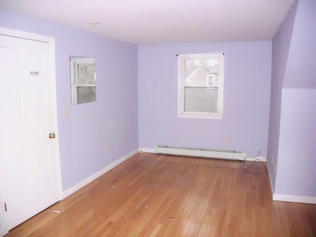 7 Coach Light Road Centerville, MA 02632 - Photo 12 of 22 an empty room with wooden floor and windows