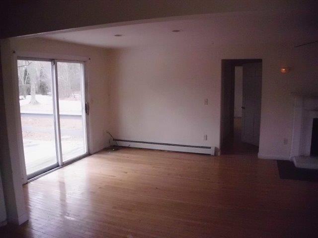 7 Coach Light Road Centerville, MA 02632 - Photo 2 of 22 a view of an empty room with wooden floor and a window